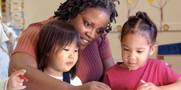 Teacher with children at Sugar Bear Day Care